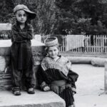 boy standing beside child standing beside concrete surface 3103373