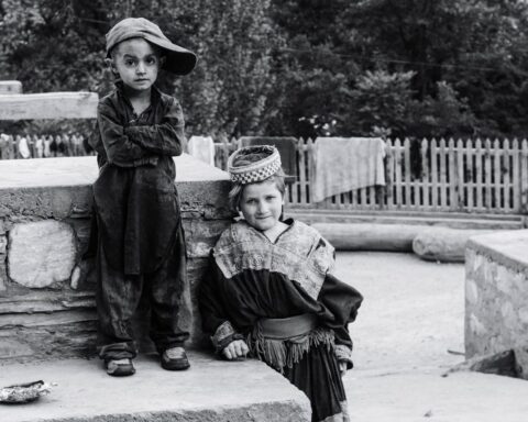 boy standing beside child standing beside concrete surface 3103373